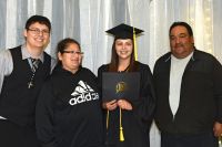 LLTC student at graduation ceremony with family