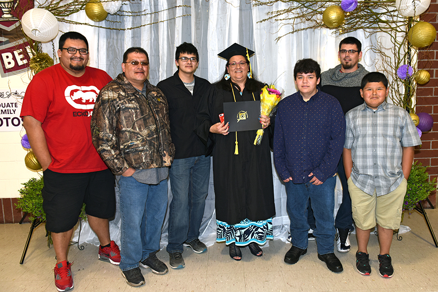 LLTC student at graduation ceremony with family