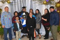 LLTC student at graduation ceremony with family