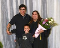 LLTC student at graduation ceremony with family