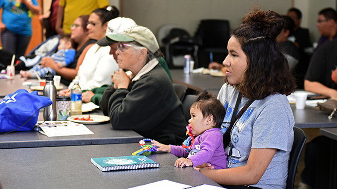 Student and child at Orientation in the drum room.